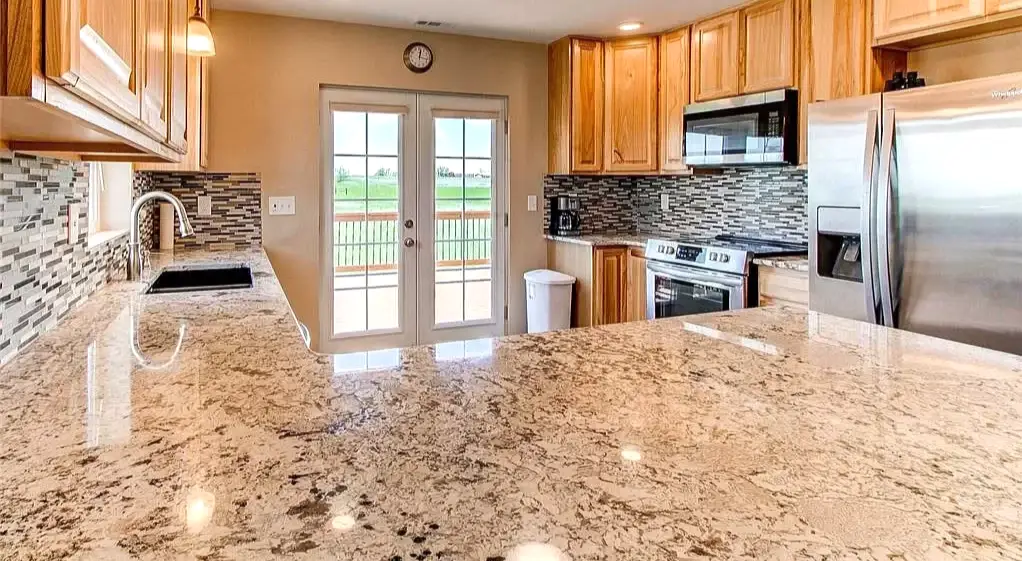 A spotless, freshly cleaned kitchen with granite countertops